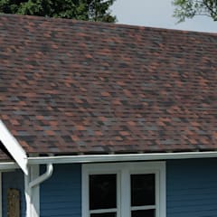 Blue home with white trim and Duration Designer shingles in Bourbon color.