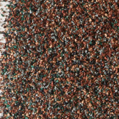 Closeup photo of shingle granules in brown, gray, green, and tan colors
