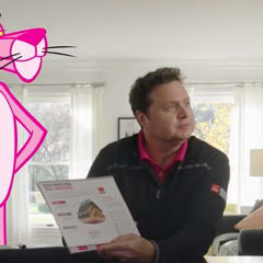 Man and woman meeting with a roofing contractor, sitting at their kitchen table with the Pink Panther standing nearby