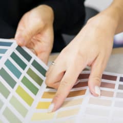 Photo of two people looking through a color swatch booklet