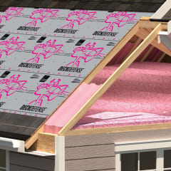 Residential roof with shingles torn away to reveal underlayment products on the roof.