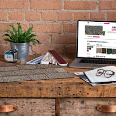 Wood desk with shingle samples, brochures, laptop, and notebook spread out