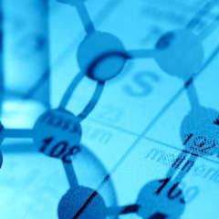 Chemical containers against a blue periodic table background