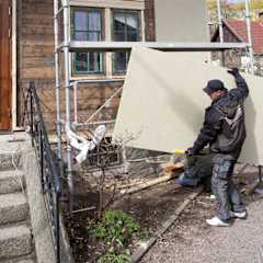 Paroc stone wool insulation being fitted to a building by a male worker