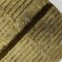 a piece of stone wool with the Rewool logo 