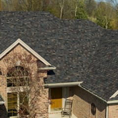 Tan brick home with Owens Corning Duration Designer shingles in Black Sable.