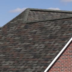 Closeup of a roof on a red brick house