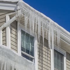 An ice dam is a ridge of ice that forms at the edge of a roof and prevents melting snowfrom draining off the roof.