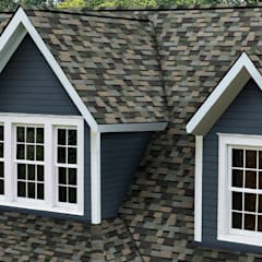 Home with blue siding and dormers with white trim and Owens Corning Trudefintiion Duration Designer shingles in Evergreen Mist.