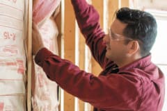 CPerson installing wall insulation
