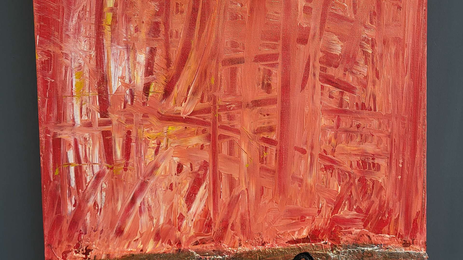   Abstract painting with textured red brushstrokes above a rough brown section featuring black symbols.
