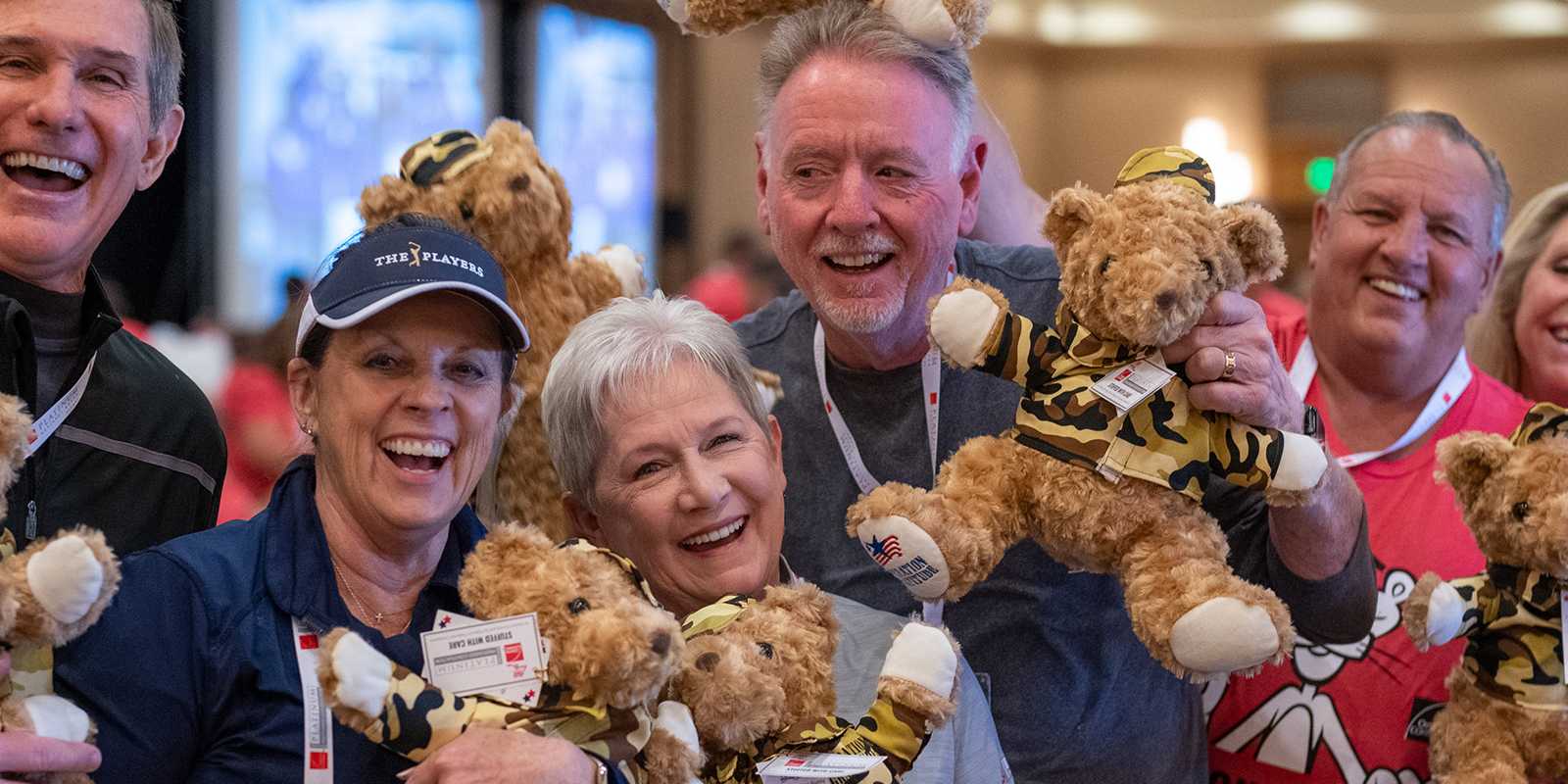 Owens Corning Roofing Contractors holding stuffed bears for a service project