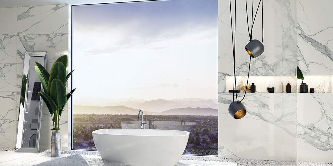 Luxury bathroom with freestanding white bathtub, large panoramic window overlooking scenic landscape, marble walls, modern pendant lights, and indoor plant decor.