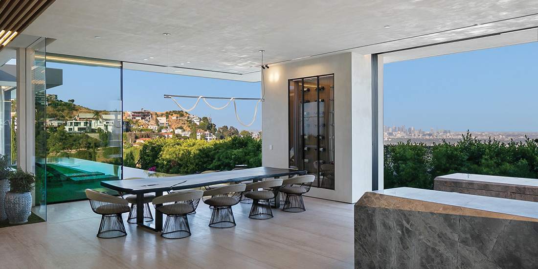 Modern open-concept dining area with floor-to-ceiling glass walls, panoramic city view, sleek dining table with designer chairs, and contemporary lighting fixtures.
