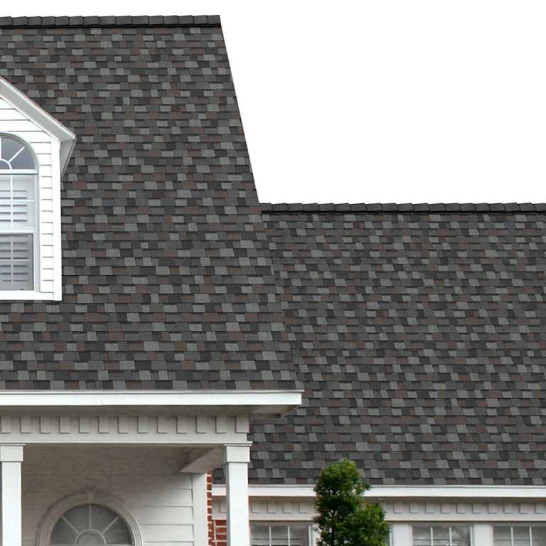 The porch entryway to a home depicts how well Gray Tweed TruDefinition® Duration® light gray, dark gray, brown, and black shingles pair with the white horizontal paneling and a woodgrain door with white columns.