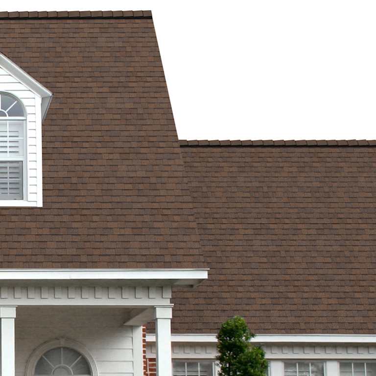 The porch entryway to a home depicts how well Forest Brown TruDefinition® Duration® COOL medium warm brown shingles pair with the white horizontal paneling and a woodgrain door with white columns.