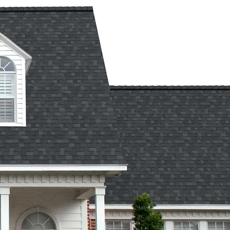 The porch entryway to a home depicts how well Oakridge® Onyx Black shingles pair with the white horizontal paneling and a woodgrain door with white columns.
