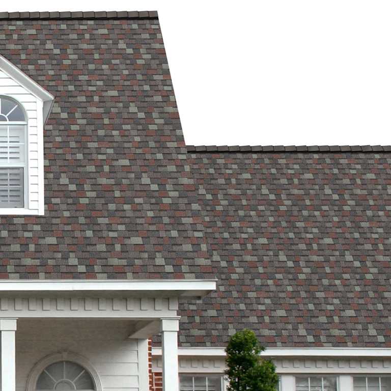 The porch entryway to a home depicts how well Colonial Slate TruDefinition® Duration® dark gray, light grays, and red shingles pair with the white horizontal paneling and a woodgrain door with white columns.