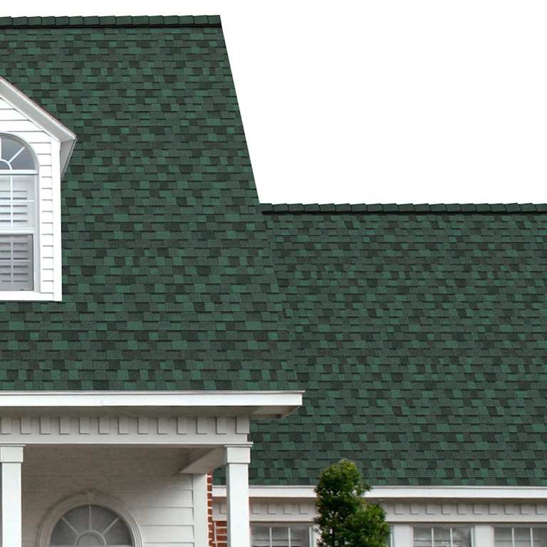 The porch entryway to a home depicts how well Chateau Green TruDefinition® Duration® green, dark grey and black shingles pair with the white horizontal paneling and a woodgrain door with white columns.