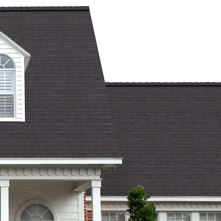 The porch entryway to a home depicts how well Night Sky TruDefinition® Duration® COOL dark gray-black shingles pair with the white horizontal paneling and a woodgrain door with white columns.