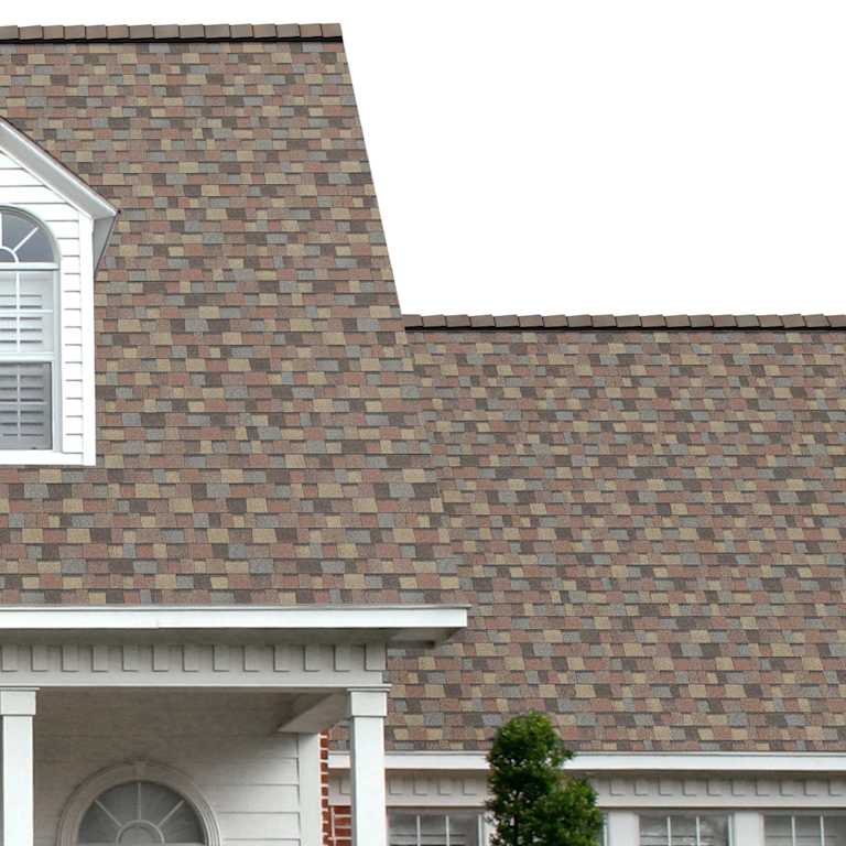The porch entryway to a home depicts how well Summer Harvest TruDefinition® Duration® golden tan, brown, red, blue and black shingles pair with the white horizontal paneling and a woodgrain door with white columns.