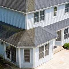 Grey house with grey roofing shingles with half showing "before" and "after" cleaning the roof.