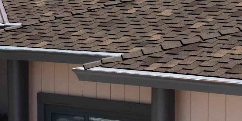 WoodStart Starter Strip Shingle installed on a tan home under Woodcrest Chestnut shingles.