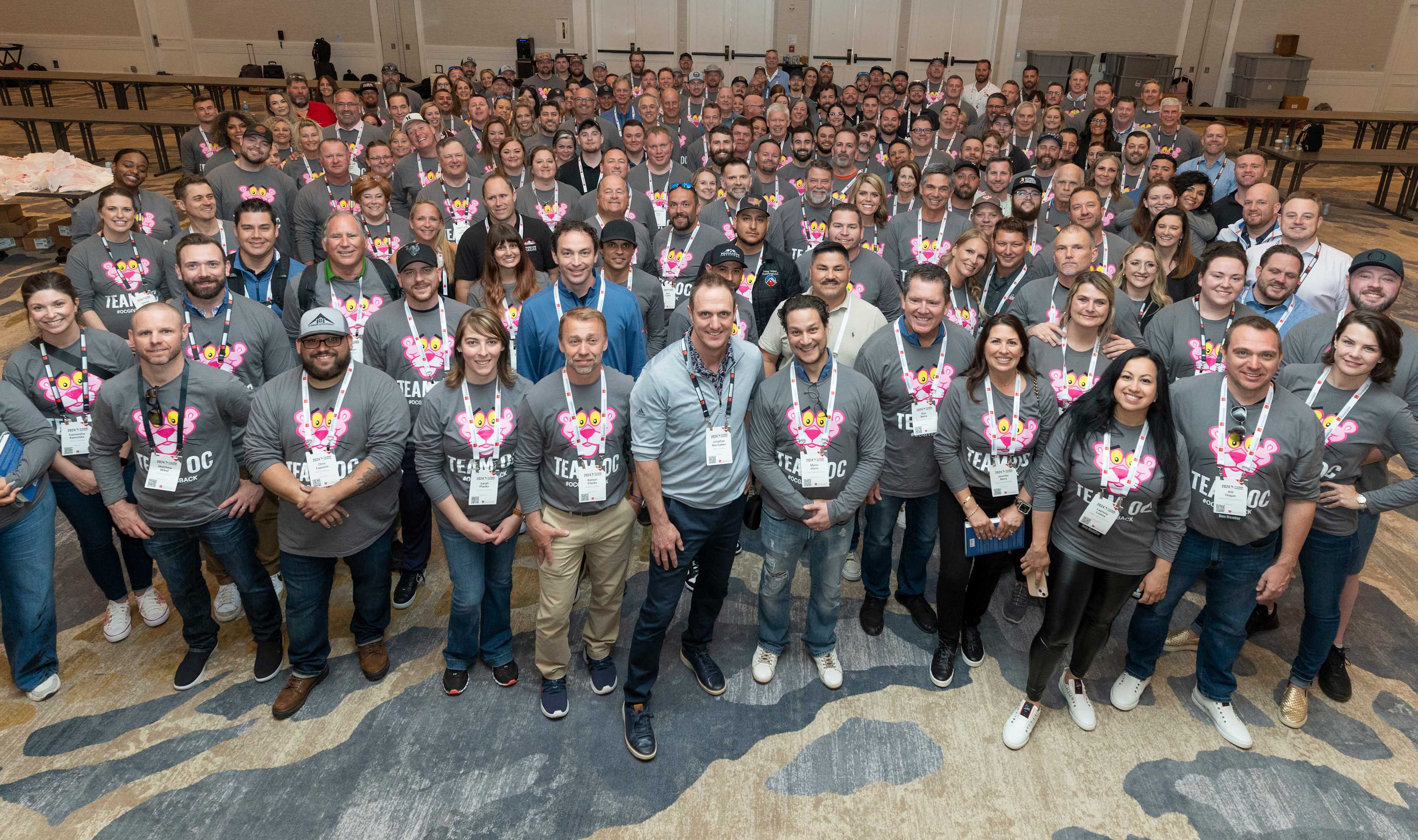 A large group of Owens Corning Platinum Contractors standing together wearing Team OC shirts.