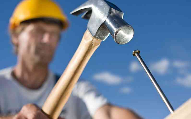 Contractor hammering a nail