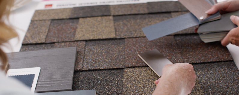 Women using Owens Corning Shingle Sample Board to pair with flooring and paint swatches