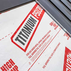 Contractor walking on three different metal roof underlayments on a roof deck