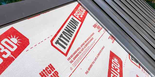 Contractor walking on three different metal roof underlayments on a roof deck