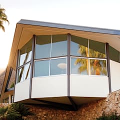 Photo of a house with windows and palm trees