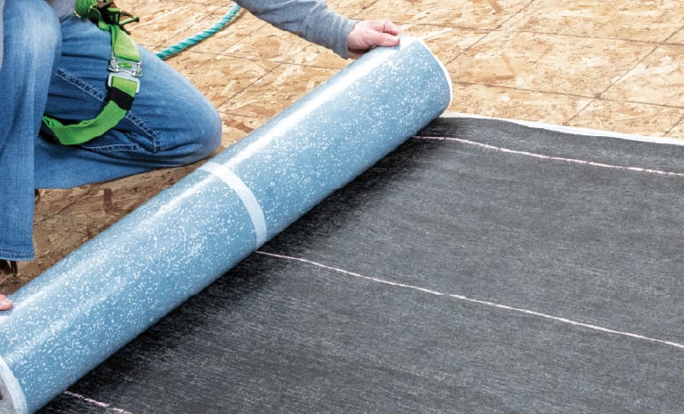 Weatherlock underlayment being unrolled on a roof deck.