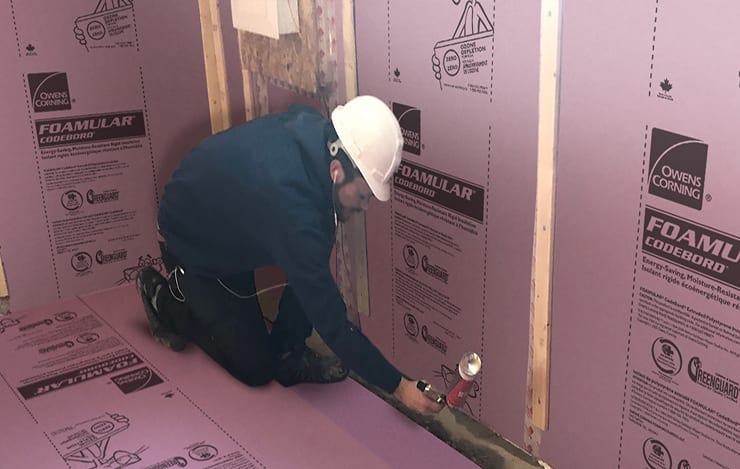 Contractor applying Foamular insulation