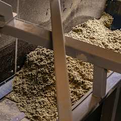 crushed stone wool on the conveyor at OC Paroc Parainen factory waste handling station.