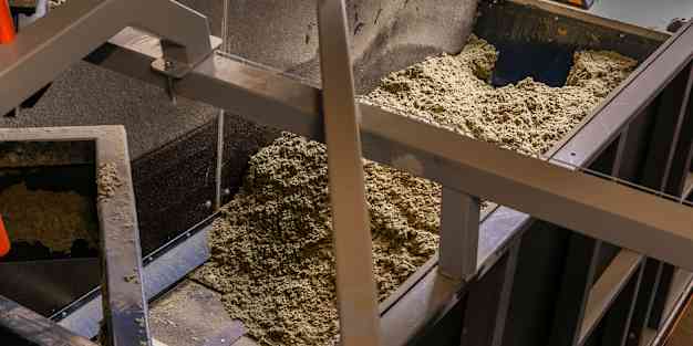 crushed stone wool on the conveyor at OC Paroc Parainen factory waste handling station.
