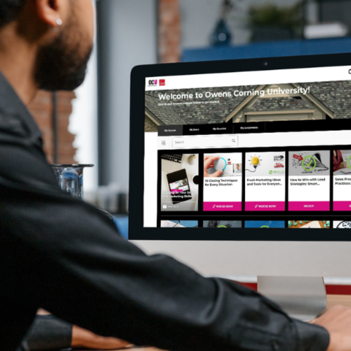 Man wearing a long sleeve black shirt using the OCU website on a computer