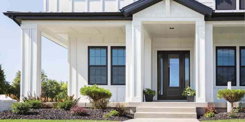 Elegant double entry door in black with intricate glass panels and a white doorknob.