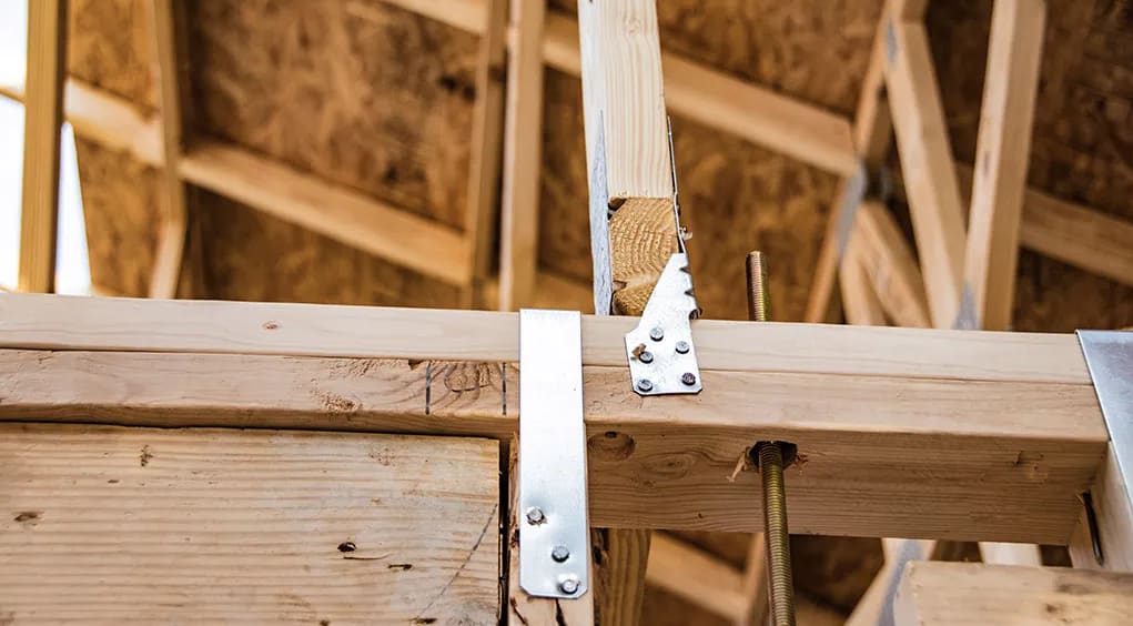 Wooden attic rafters with a hurricane twist strap