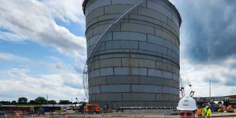 Worker standing by an impoundment basin at an LNG facility