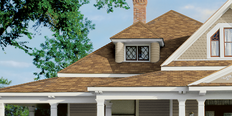 Supreme three tab shingles installed on a tan home with white accents.