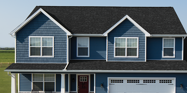 Oakridge shingles installed on a blue siding home with white trim.