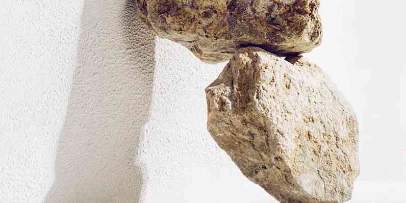 Photo of pieces of stone leaning up against a wall