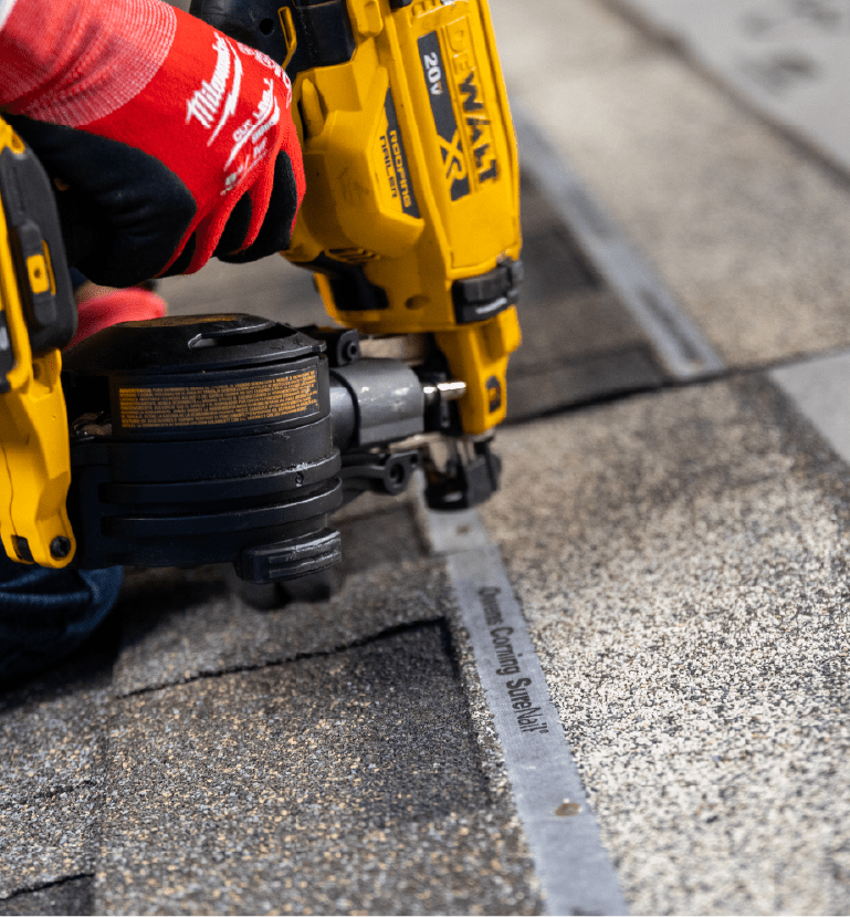 Duration Shingles being nailed to a roof deck with a yellow dewalt nail gun.