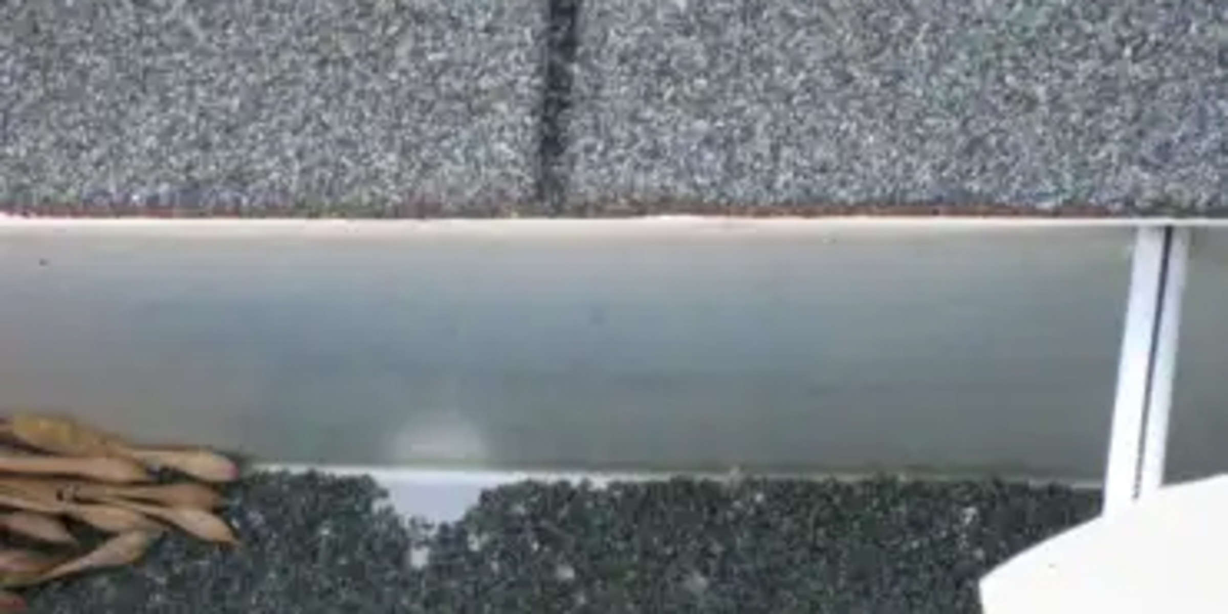 Roof shingle granules in gutter