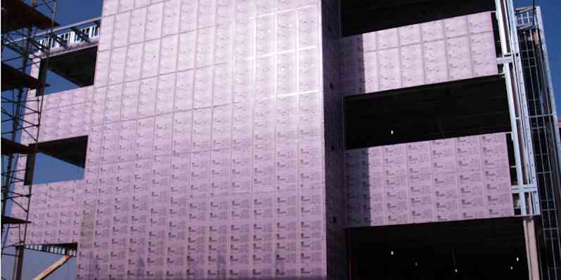 Exposed xps pink insulation foam board within exterior of a commercial buiding