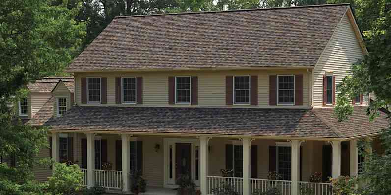 Two-story house with tan siding and Summer Harvest shingles