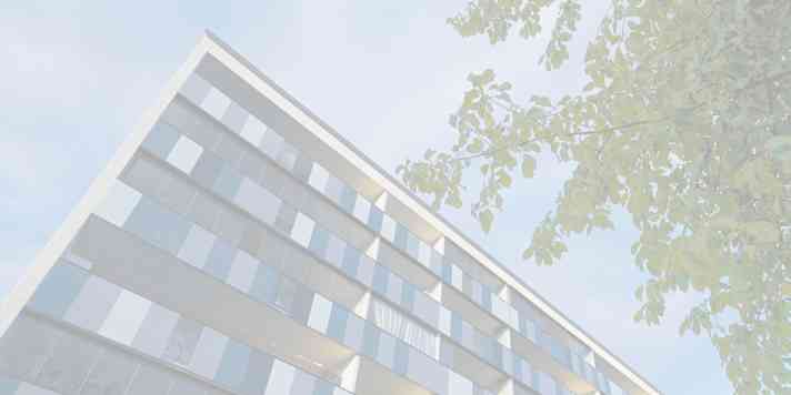 A building seen from beneath with the sky in the background.