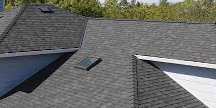 Photo of a light colored house with gray COOL roofing shingles